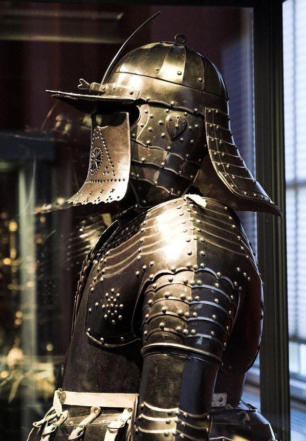 an armor and helmet displayed in a glass case