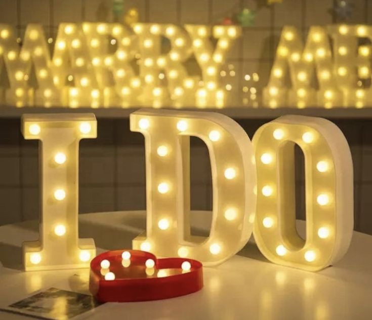 lighted letters spelling out the word idol on a table