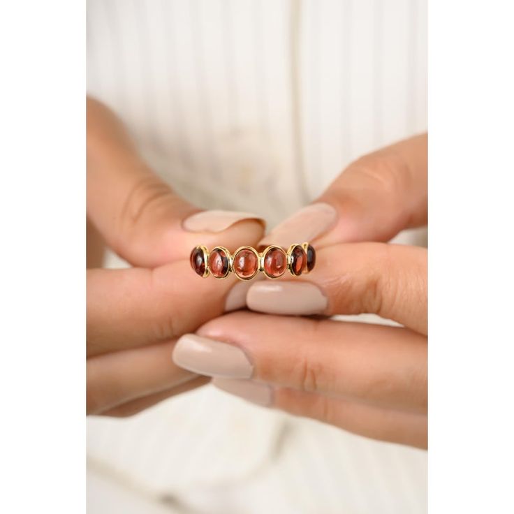 This is part of Chairish’s Fine Jewelry assortment.  Round Cabochon Garnet Eternity Band Ring in 18K Gold symbolizes the everlasting love between a couple. It shows the infinite love you have for your partner. The round shape represents love which will continue and makes your promises stay forever. Garnet helps with love and relationships. Lightweight and gorgeous, this is a perfect mother's day gift, Engagement Gift, Bridal Shower Gift, Gift For Love, Gift For Sister, Mother Daughter Gift, Brid Luxury Oval Gemstone Stackable Rings, Elegant Multi-stone Open Birthstone Ring, Elegant Adjustable Ruby Stackable Ring, Elegant Adjustable Stackable Ruby Ring, Elegant Gemstone Stackable Rings For Anniversary, Luxury Gemstone Stackable Rings With Open Design, Luxury Gemstone Stackable Open Rings, Luxury Stackable Open Ring With Gemstones, Oval Stackable Fine Jewelry Rings For Anniversary