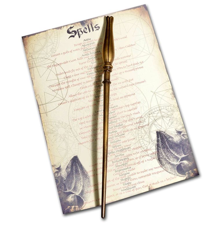 a harry potter wand on top of an old book with some writing in the background