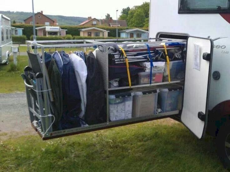 the back of a trailer with clothes and other items in it's storage compartment