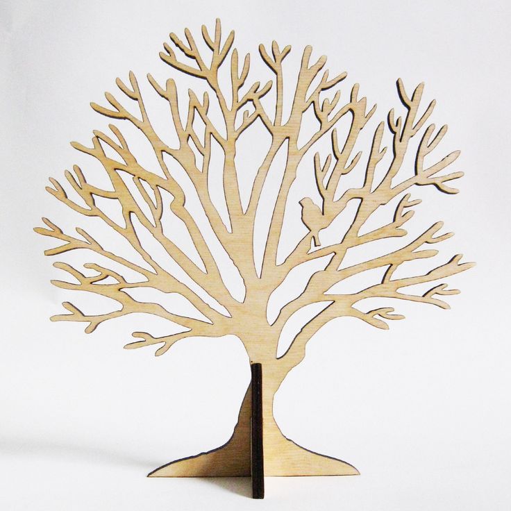 a wooden cutout of a tree on a white background