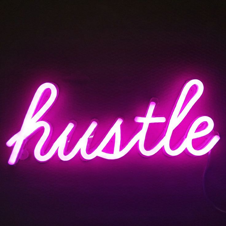 a purple neon sign that says hustle