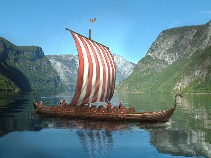 a boat with people on it is floating in the water near some mountains and cliffs