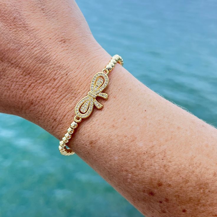 Durable and stylish, our waterproof bracelet is crafted for both functionality and fashion. Perfect for any occasion, it's the ideal accessory for those who appreciate durability and timeless elegance. Perfect for the minimalist and a beautiful piece to layer with. A true versatile statement piece that you can wear straight from the pool to dinner! - 18K gold plated / stainless steel - Waterproof technology - Elastic bracelet measures 56mm inner diameter. Gold Beaded Bracelets With Adjustable Length, Trendy Flexible Bangle Bracelets, Trendy Bangle Bracelet, Adjustable Flexible Bracelet Jewelry, Chic Adjustable Gold Bracelet For Gift, Chic Adjustable Bracelets, Adjustable Trendy Bangle Chain Bracelet, Trendy Adjustable Bangle Chain Bracelet, Adjustable Flexible Gold Bracelet