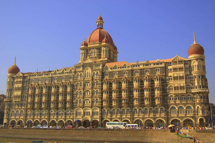 a large building with many windows and towers on the top of it's sides