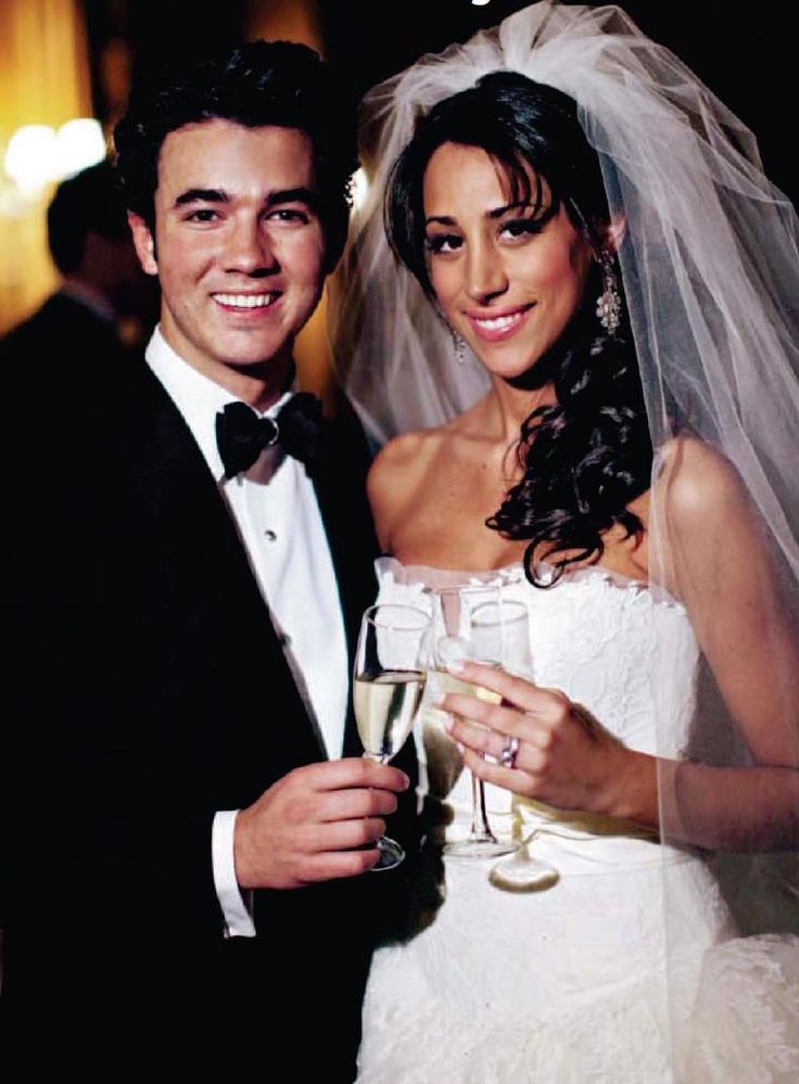 a bride and groom posing for a photo with champagne glasses in front of their faces