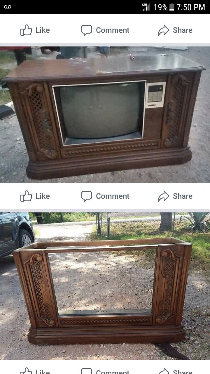 an old tv sitting on top of a wooden table next to another television with the same screen