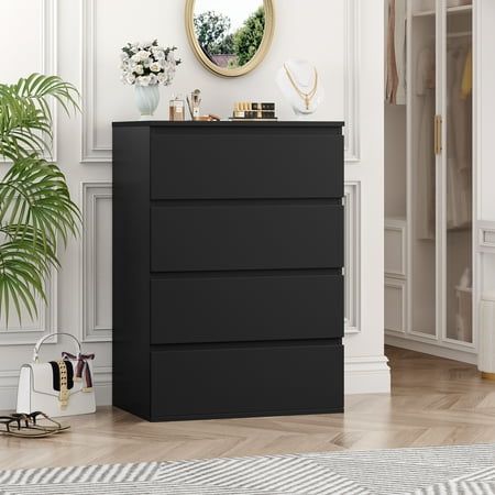 a black chest of drawers in a white room