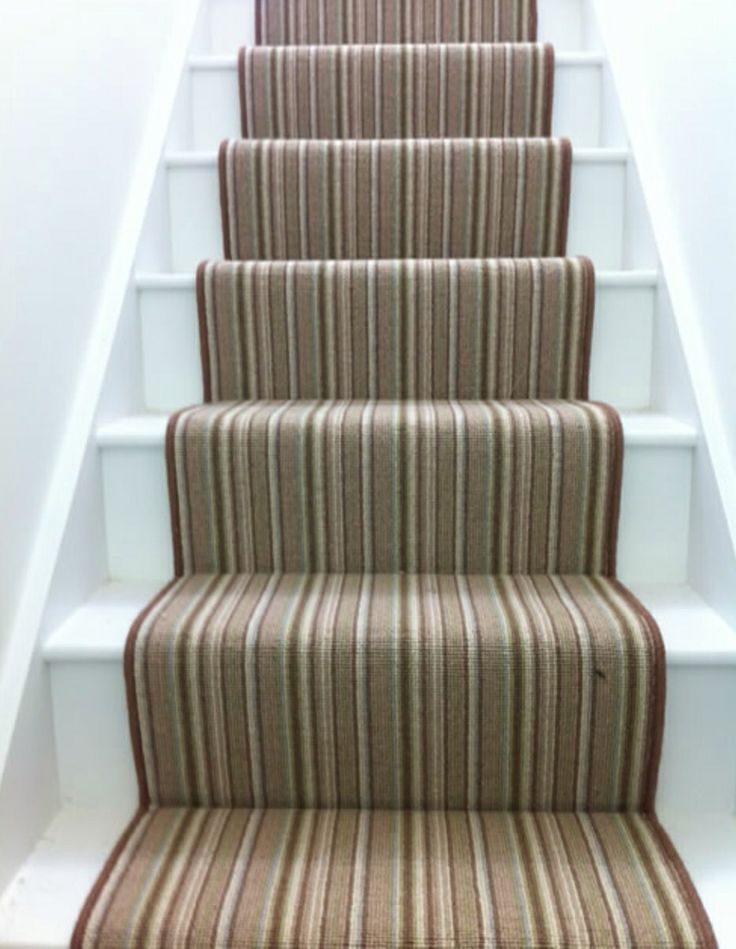 a carpeted staircase leading up to the top floor