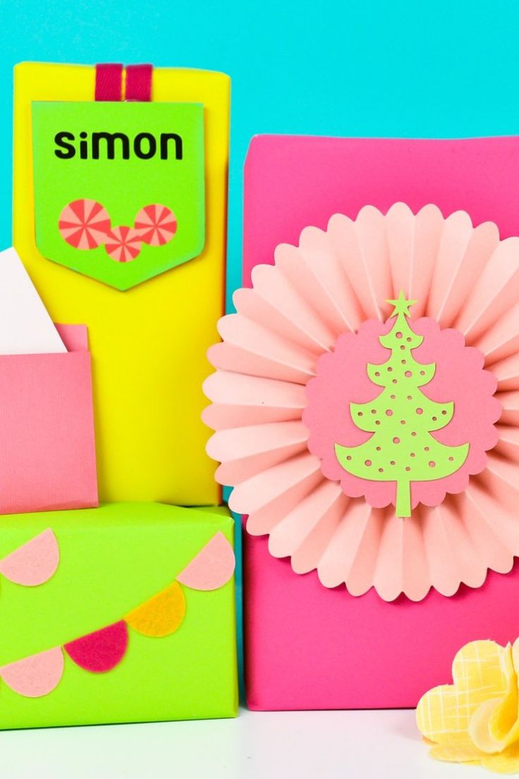 some colorful boxes with paper decorations on them