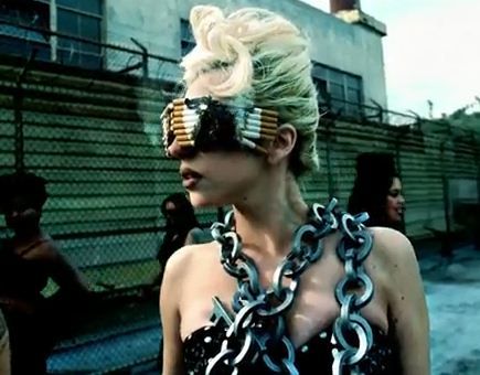 a woman with chains around her neck and sunglasses on