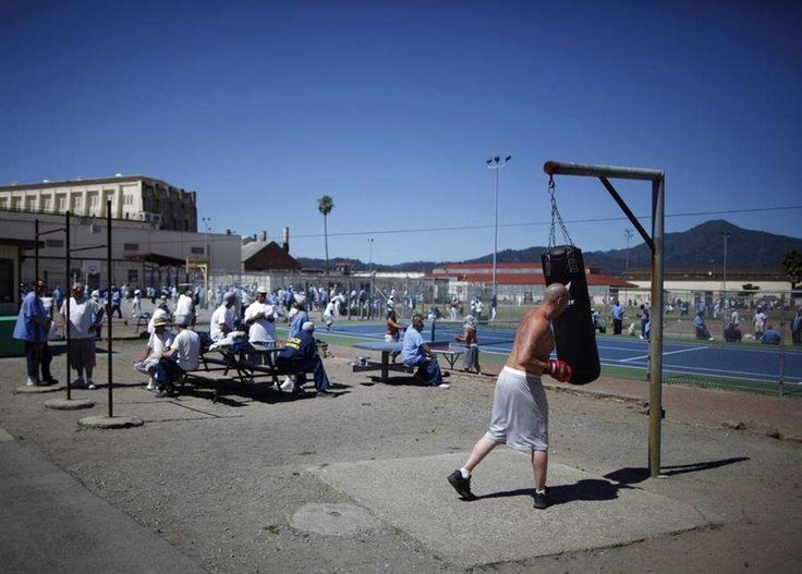 a group of people are playing basketball on the court in front of an outdoor arena