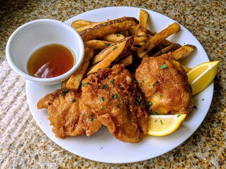 fried chicken and french fries on a plate with dipping sauce