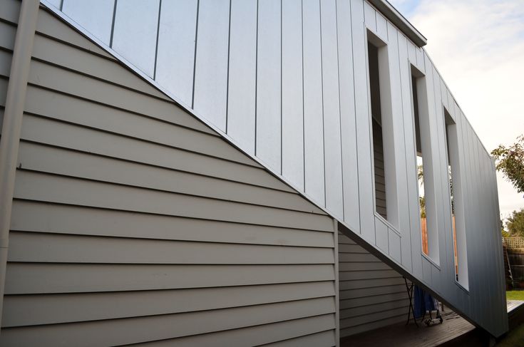 the side of a house with siding and windows