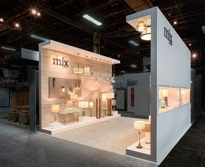 a trade show booth with lights and furniture on the floor in front of it's display area