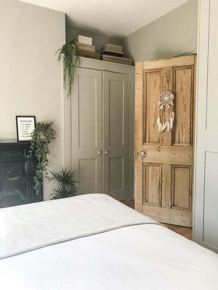 a bedroom with a white bed and wooden doors