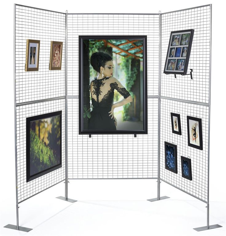 an open white room divider with pictures on it