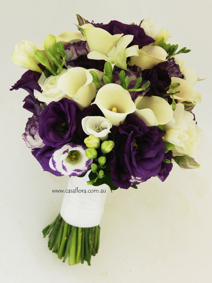 a bridal bouquet with purple and white flowers