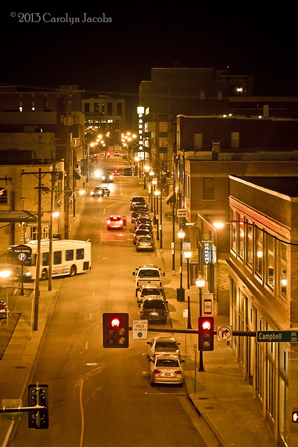 a city street at night filled with traffic