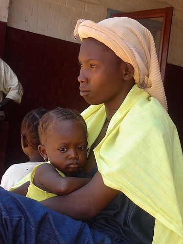 a woman holding a small child in her lap