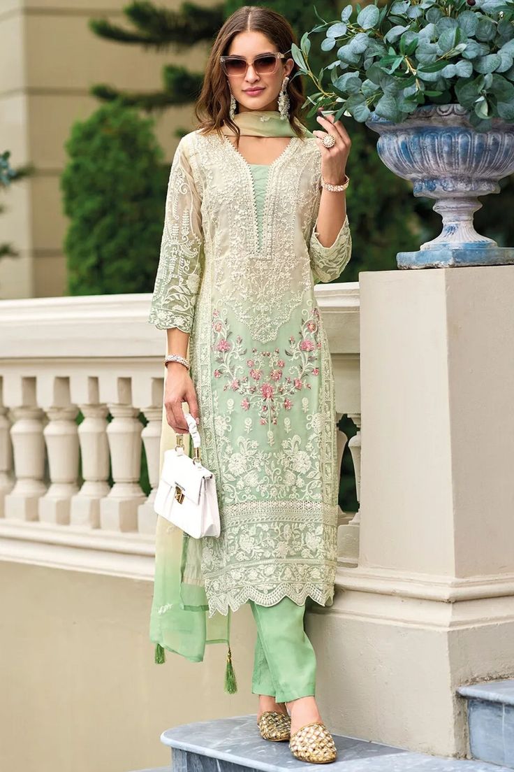 This exquisitely designed soft organza pant style suit Pakistani Suit is embellished with delicate resham thread work, beads, sequins, and lace work, making it a standout piece for any occasion. From festive celebrations to social gatherings and cultural events, this pant suit showcases the ultimate combination of style and grace. Top: Soft Organza Silk Bottom: Blended Silk Dupatta: Embroidered Organza Silk Resham thread work, beads, sequins, and lace work Top Length: 44"-46" Bottom Length: 40" Phulkari Pants, Lucknowi Kurta, Gharara Suits, Embroidery Suits Punjabi, Patiala Salwar Suits, Phulkari Dupatta, Chikankari Suits, Bridal Dupatta, Kurta Dress