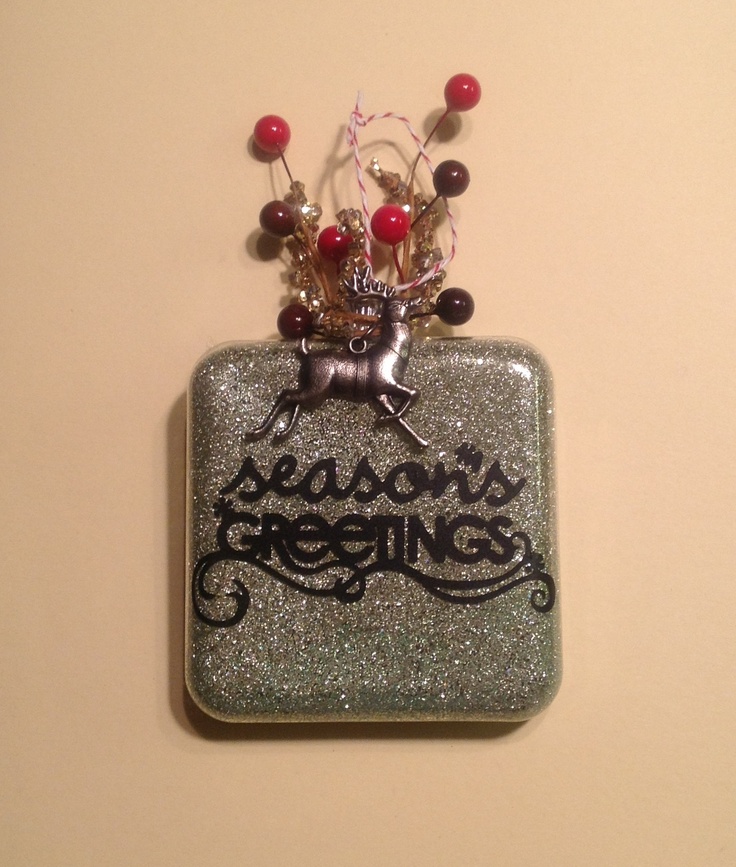 there is a glass ornament with some beads on it that says season's greetings