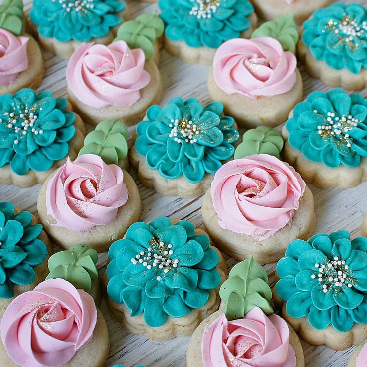 some cupcakes with pink and blue frosting on them