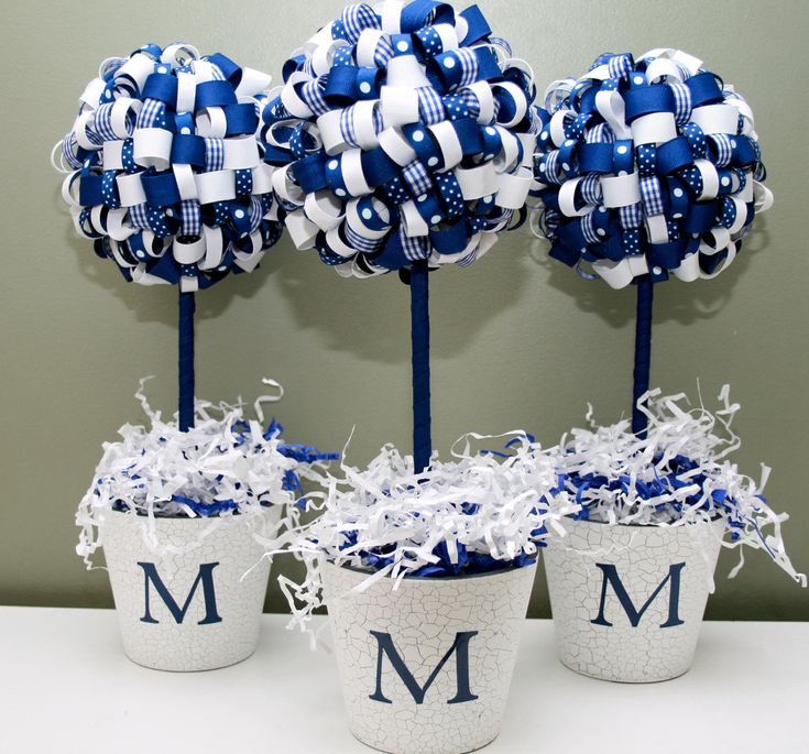 three blue and white flower pots with monogrammed bows