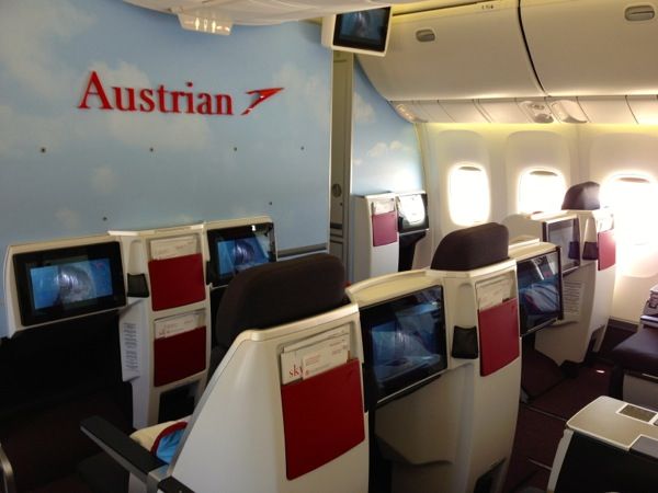 the inside of an airplane with several televisions