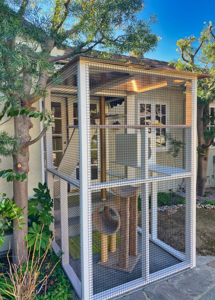 a large bird cage in front of a house