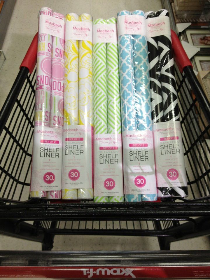 a shopping cart filled with lots of different colored wrapping paper on top of each other