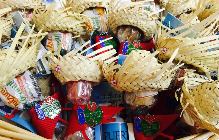 a basket filled with lots of different types of candy and straw hats on top of each other