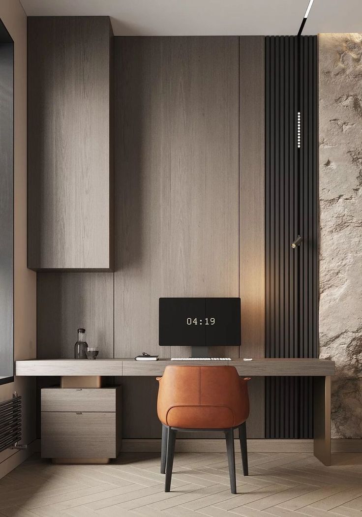 a modern home office with a stone wall and wood paneling, along with a leather chair