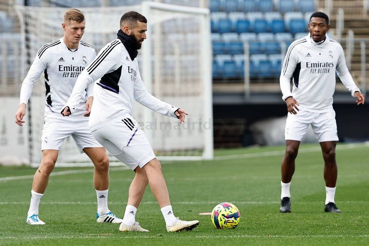 three men are playing soccer on the field