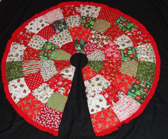 a red and green quilted christmas tree skirt on a black tablecloth with white polka dots