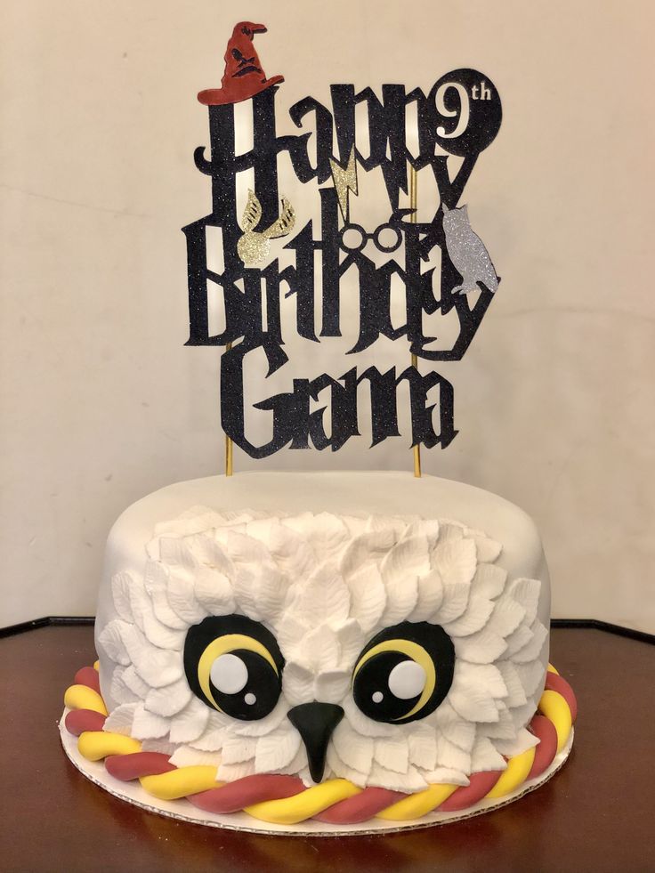 a birthday cake decorated with an owl and the words happy birthday gama on top