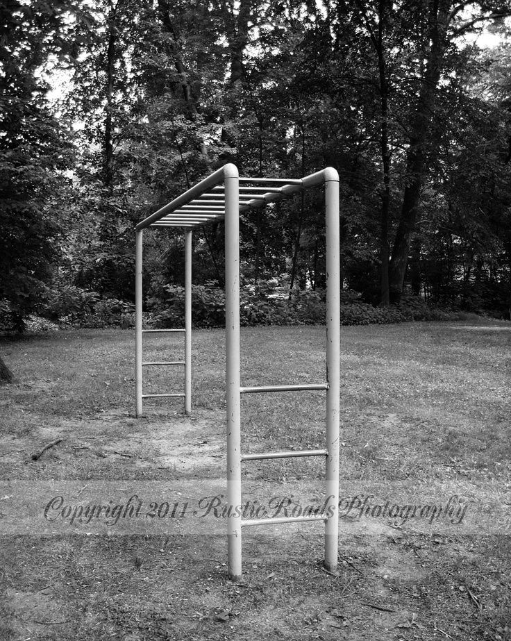 an empty metal structure in the middle of a field