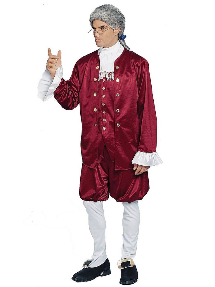 a man in a red suit and white shirt is standing with his hand up to the side