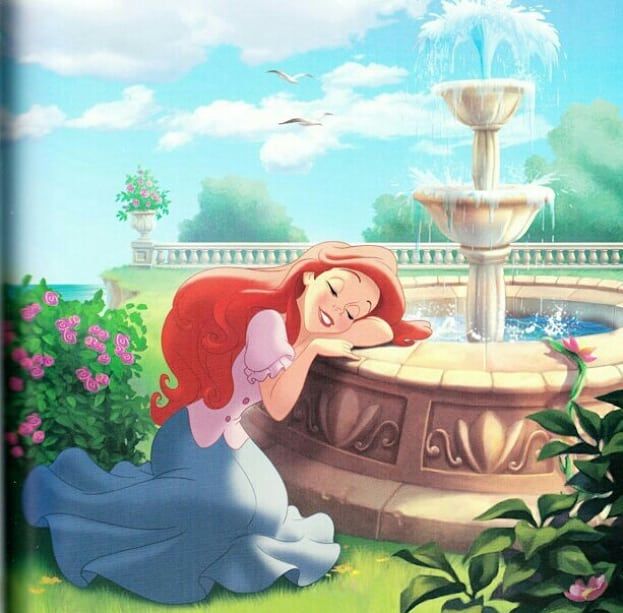 ariel from the little mermaid sitting in front of a fountain with her hands on her face