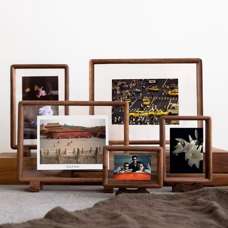 there are four frames on the floor with pictures in them