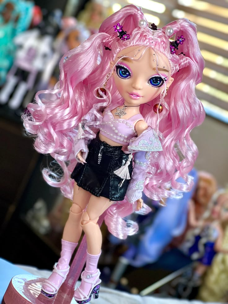 a close up of a doll with pink hair