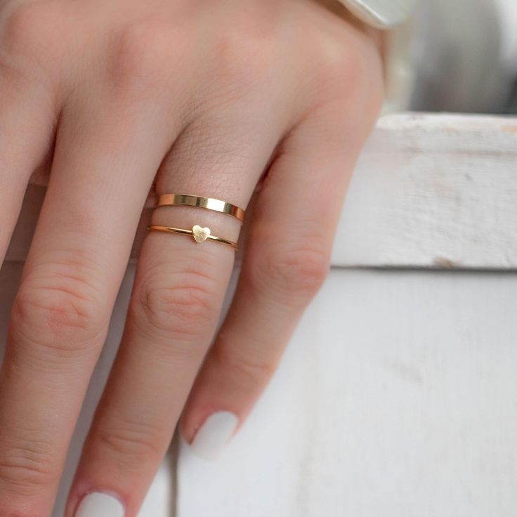 Our super fine and dainty heart Gold filled ring is perfect for a minimalist statement. So versatile our heart ring is great for stacking and pretty enough to stand on it's own. Mix and Match to stack your favourite rings. Simple, clean and so pretty 14 Karat Gold Filled Heart ring. Won't tarnish! Ring sizes 6 through 8 available. Rings sold as individuals if you would like multiple please select from drop down menu. * ＤＥＴＡＩＬＳ - 14k gold filled - Ships next business day - Made in Oakville, ON. * Minimalist Heart Shaped Stackable Promise Rings, Dainty Simple Design Heart Promise Ring, Minimalist Heart Ring With Simple Design, Minimalist Heart-shaped Ring With Simple Design, Dainty Gold Heart Ring For Promise, Elegant Everyday Heart Ring With Charm, Minimalist Heart Cut Stackable Rings, Dainty Heart Ring With Simple Design For Promise, Elegant Everyday Ring With Heart Charm