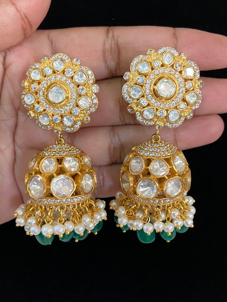 These earrings would have a luxurious, traditional jhumki design, combining modern moissanite brilliance with Kundan beauty. Elegant Round Meenakari Chandelier Earrings, Fusion Style Tilla Jhumkas Drop Earrings, Fusion Kundan Jhumkas Drop Earrings, Kundan Fusion Jhumkas, Fusion Style Kundan Jhumkas, Bollywood Earrings With Intricate Design For Reception, Elegant Drop Jhumkas For Reception, Bollywood Style Earrings With Intricate Design For Reception, Fusion Style Chandbali Bridal Earrings For Formal Occasions