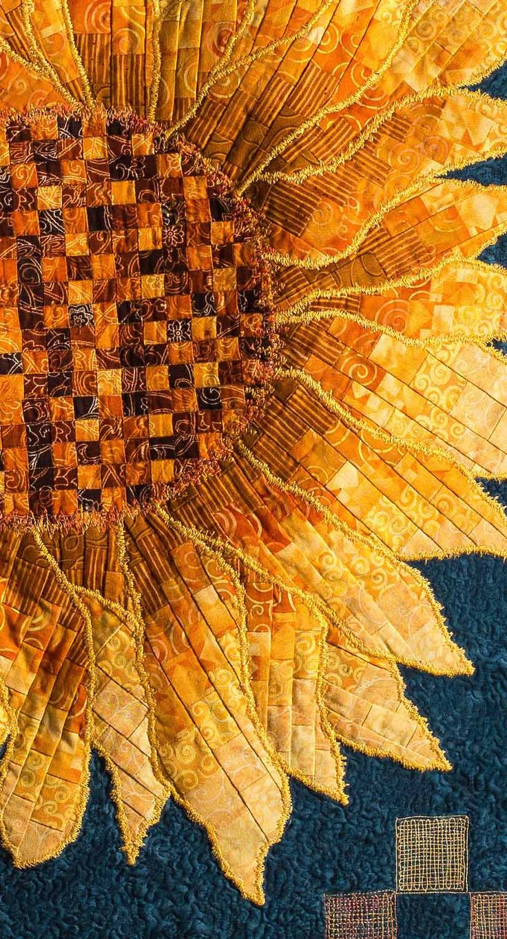 a quilted sunflower is shown on the ground