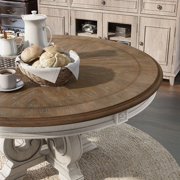 a table with bread and coffee on it in front of a dresser full of drawers