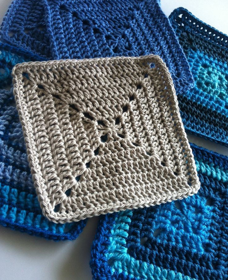 three crocheted squares are sitting on a table