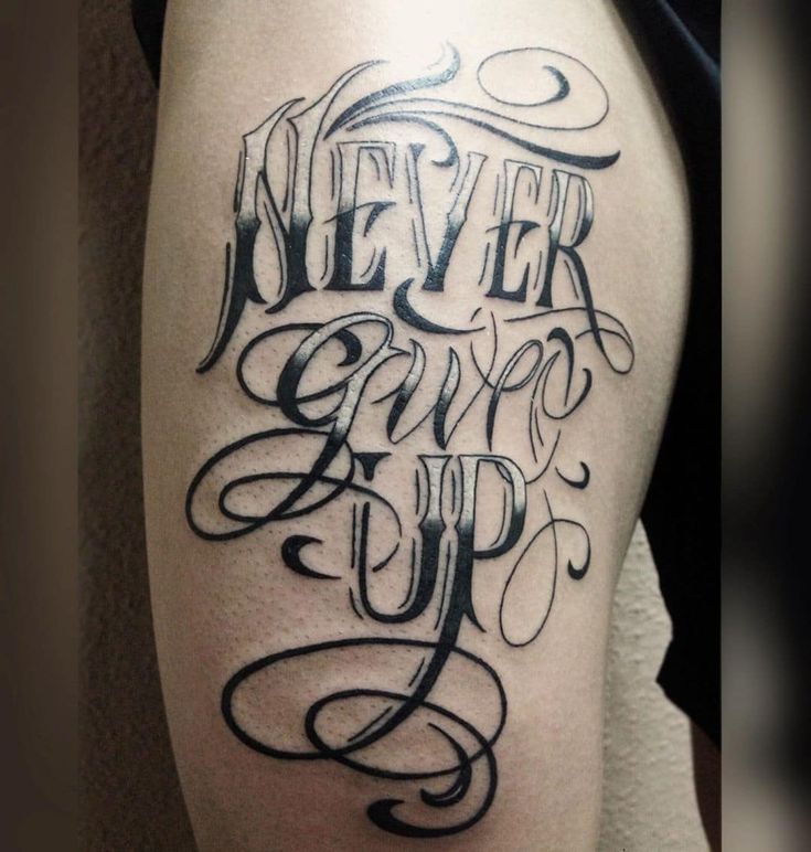 a black and white tattoo saying never give up