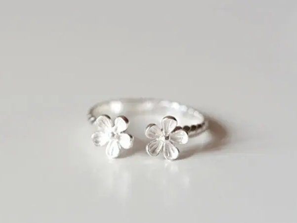 Petals Floral Adjustable stacking ring 925 Sterling Silver Flower Size:  8mm, Band approx 2mm Beautiful delicate silver ring that's adjustable and can be worn on any finger, gently stretch/close to fit. A double flower design, with linear twist marks on band. Beautiful detailing  Ships from Dublin - wrapped on a branded card, tissue paper and a sticker. Gift wrapping and personal note can be added for free - just leave a message on checkout Floral Cuff, 2017 Fashion Trends, Rings For Girls, Sterling Silver Flowers, Beautiful Gifts, Jewellery Design, Clothing Styles, Open Ring, Silver Flowers