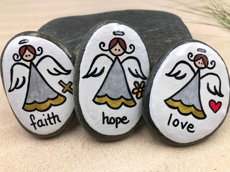 three painted rocks with the words faith, hope and love on them